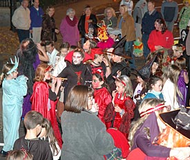Halloween trick or treaters dance and party in the street